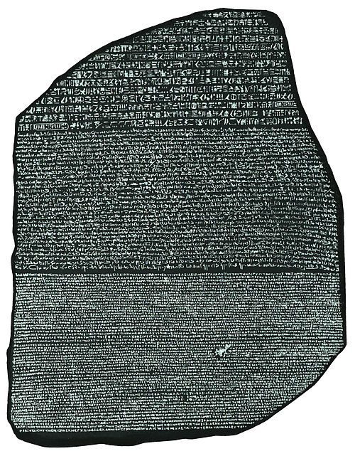 The Rosetta Stone, British Museum, London. Discovered 1799, key to deciphering ancient Egyptian hieroglyphics. The Rosetta Stone displayed in the British Museum, a granodiorite stele inscribed with the same priestly decree in three scripts: ancient Egyptian hieroglyphics, Demotic, and ancient Greek, discovered in 1799 near Rashid in the Nile Delta