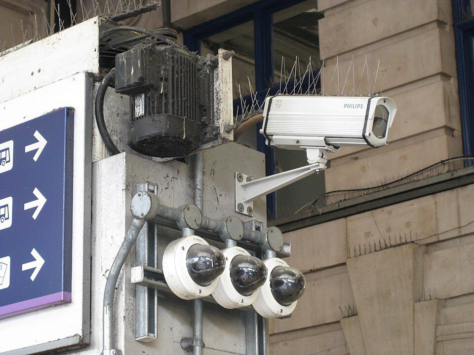 Multiple CCTV cameras mounted together in London, illustrating dense modern urban surveillance infrastructure
