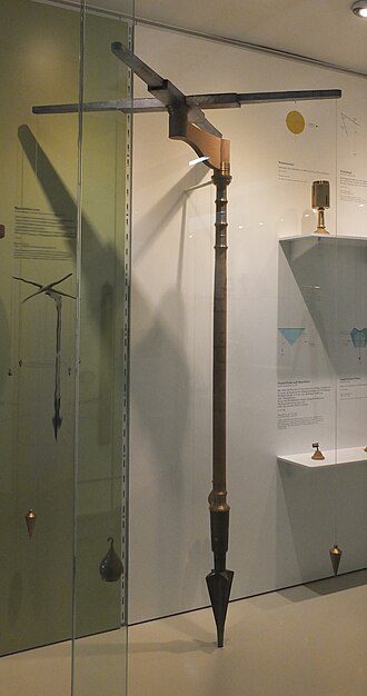 Museum reconstruction of a Roman groma and other ancient surveying tools