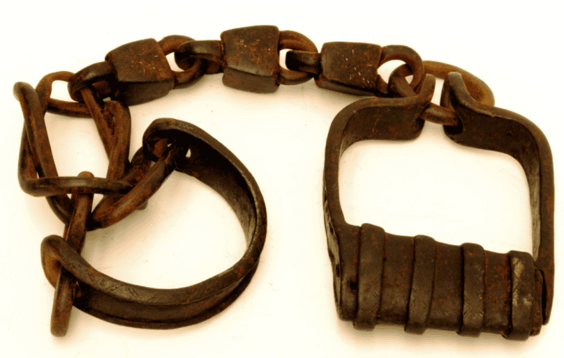 Iron shackles recovered as artifacts from the transatlantic slave trade, illustrating the human cargo pirates sometimes freed and sometimes sold
