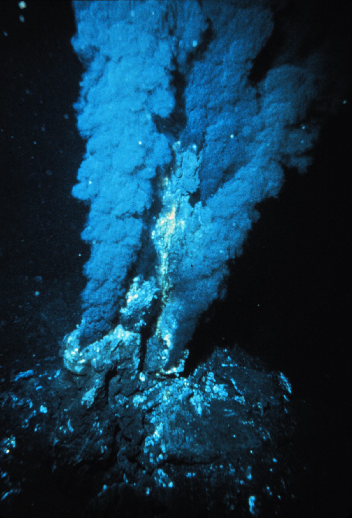 A deep-sea hydrothermal vent releasing mineral-rich superheated water on the ocean floor