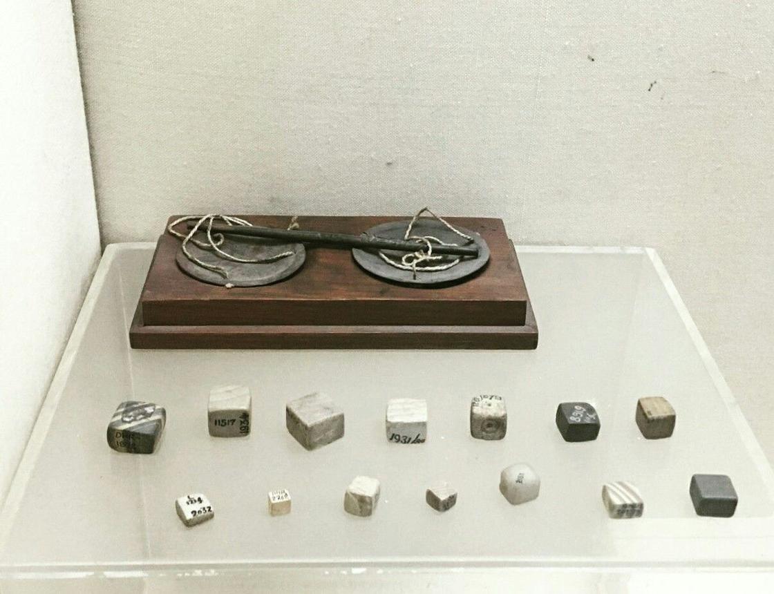 Polished chert cube weights displaying precise mathematical graduation for ancient commerce