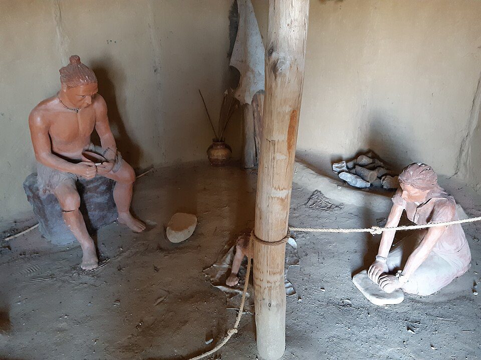 Early humans farming and harvesting crops during the dawn of agriculture in the Neolithic era