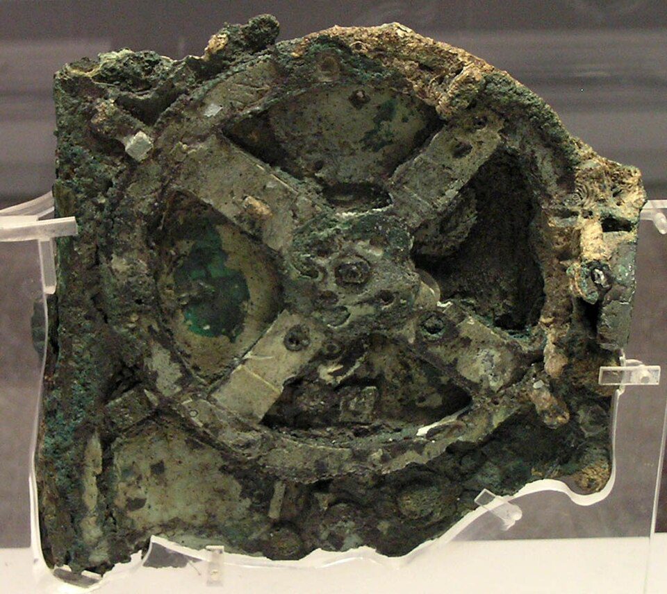 Antikythera Mechanism National Archaeological Museum Antikythera Mechanism corroded bronze gear wheel fragments on display at National Archaeological Museum, Athens