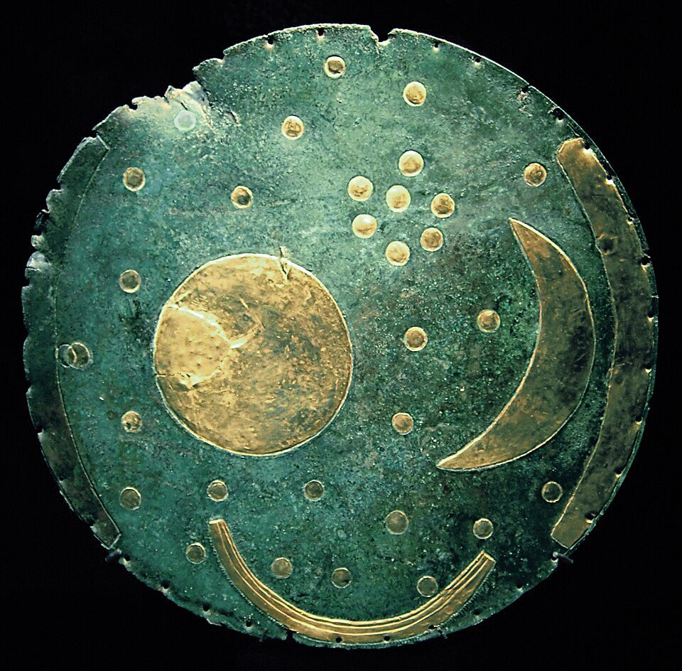 The Nebra Sky Disk, a copper plate inlaid with gold symbols representing the sun, moon, and stars.