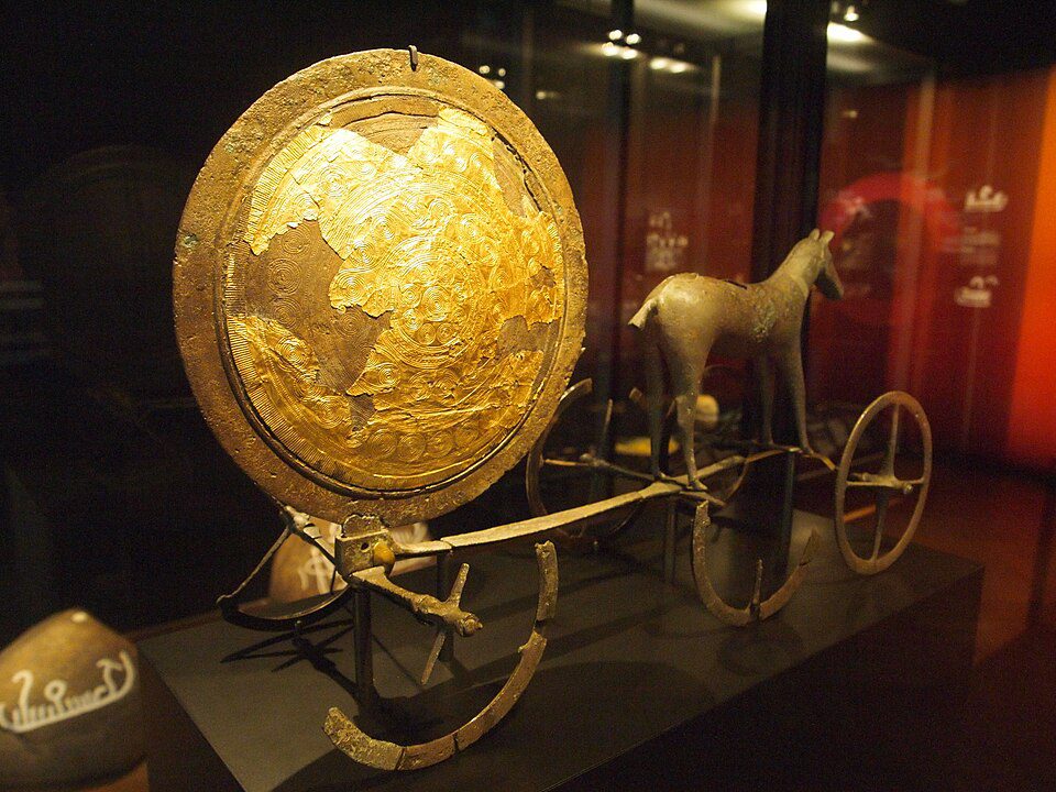 Bronze horse pulling a gilded sun disk on wheels