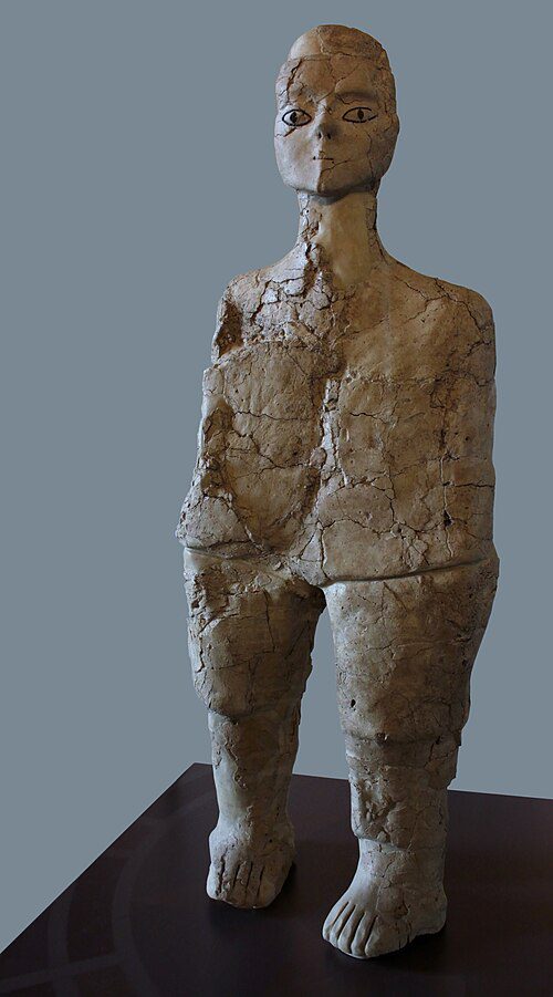 Stylized plaster human figures with wide-set painted eyes, recovered from a Neolithic settlement in Jordan