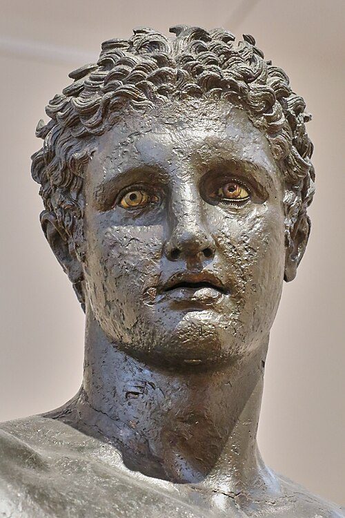 The Antikythera Ephebe, a bronze statue of a graceful young man with an outstretched arm