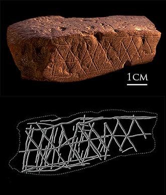 Red ochre stone from Blombos Cave featuring deliberate cross-hatched geometric engravings