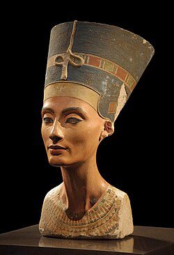 Painted limestone and stucco bust of an Egyptian queen wearing a tall blue crown