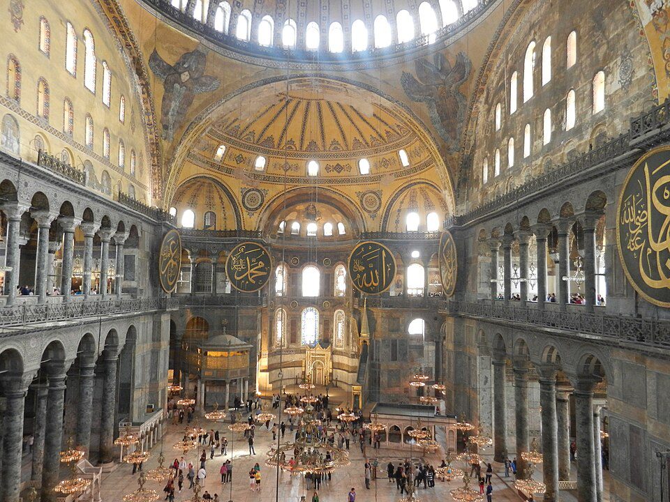 The massive, soaring domed ceiling and gold mosaics of the Hagia Sophia in Istanbul.