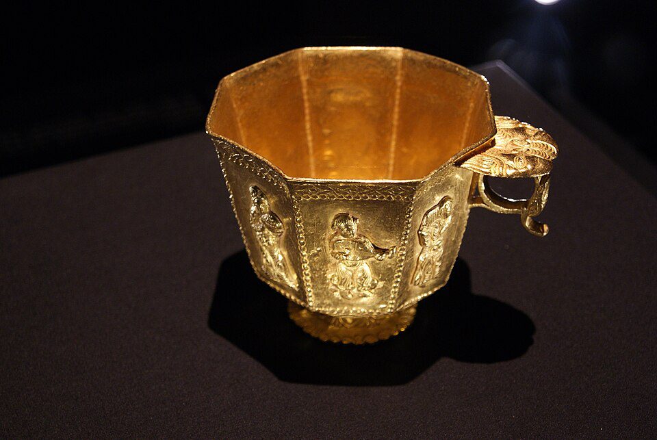 A Tang Dynasty octagonal gold cup decorated with musicians and dancers in Central Asian dress