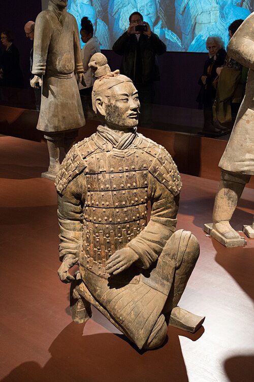 Detailed terracotta statue of a soldier in armor, kneeling in a firing position